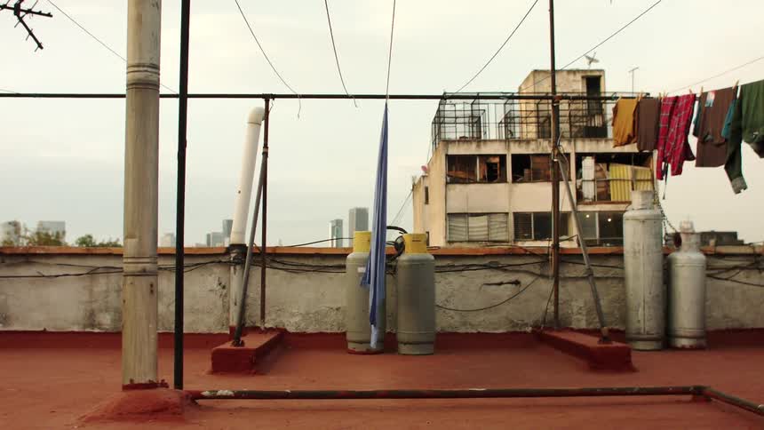 Clothes drying on a line on a red rooftop with old buildings