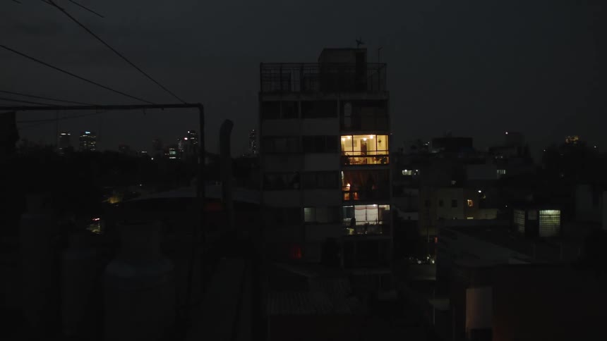 Apartments lit up in a building at night