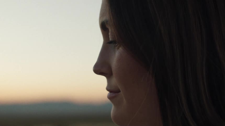 A woman is smiling outside
