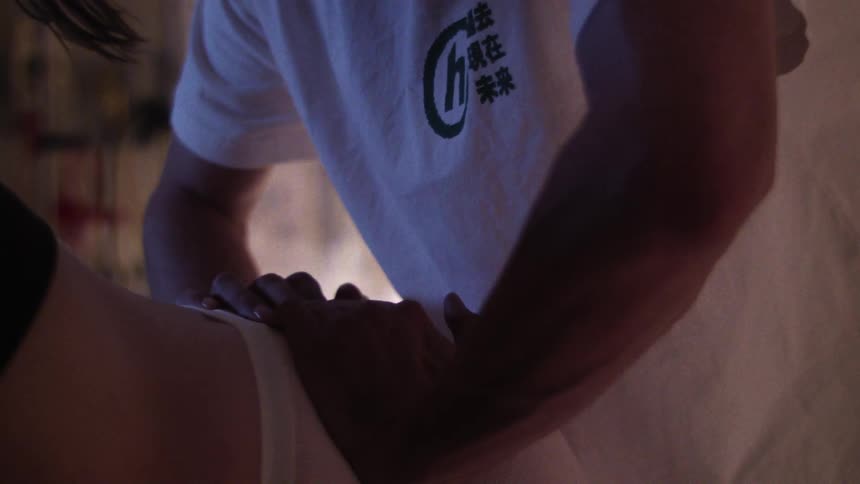 Woman wearing a white t shirt stretches her legs