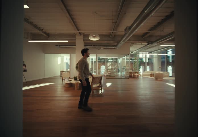 A man walks across a large open space inside a building