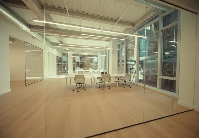 An empty meeting room with white table and chairs