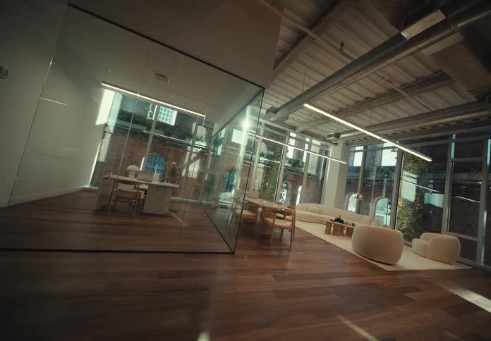 Floor to ceiling windows and glass walls allow light into rooms with minimalist decor