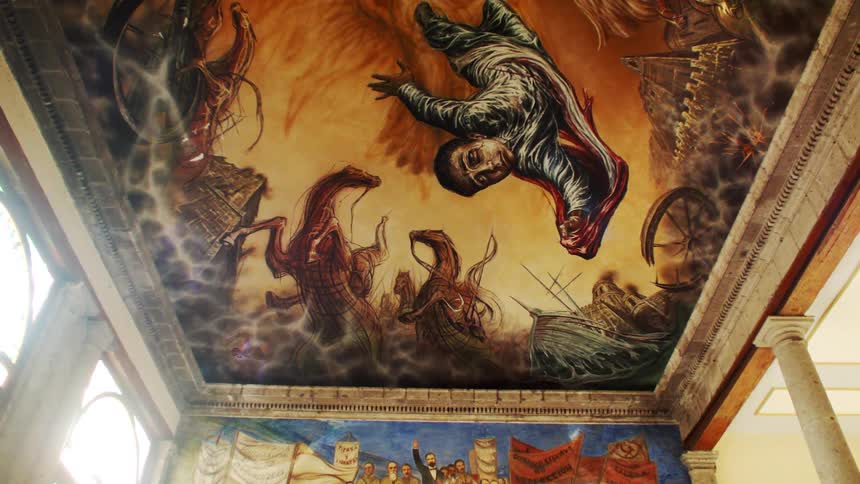 The ceiling of a building covered by a classical painting