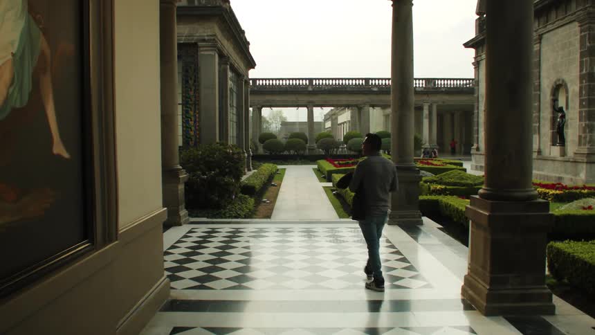 A man walking in a garden on a rainy day