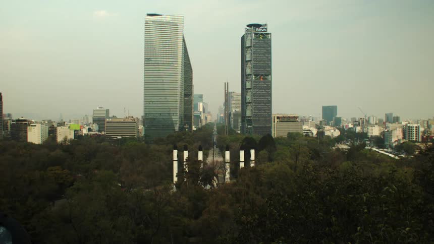 Skyline of a city with towers surrounded by forest