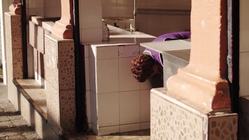 Woman wiping off store counter with a rag