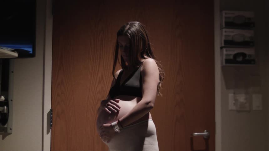 A pregnant woman in a hospital room