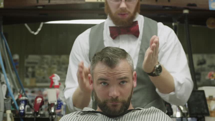 Barber finishes off a customers haircut