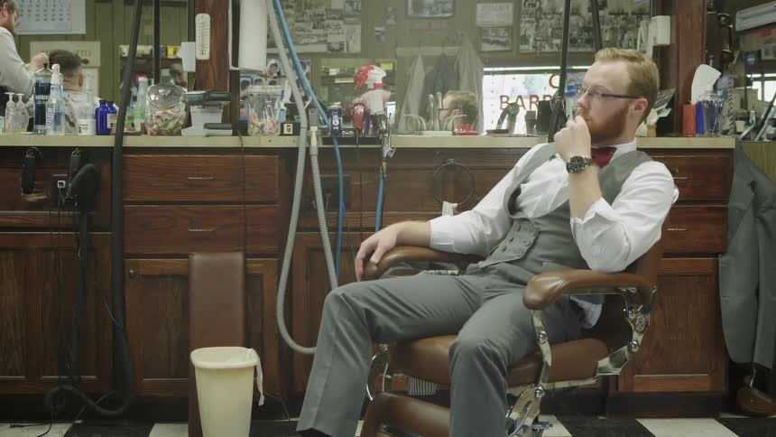 A man sits in a barber chair
