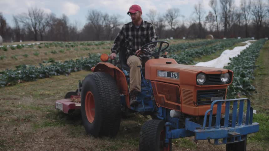 Man driving a tractor on a farm
