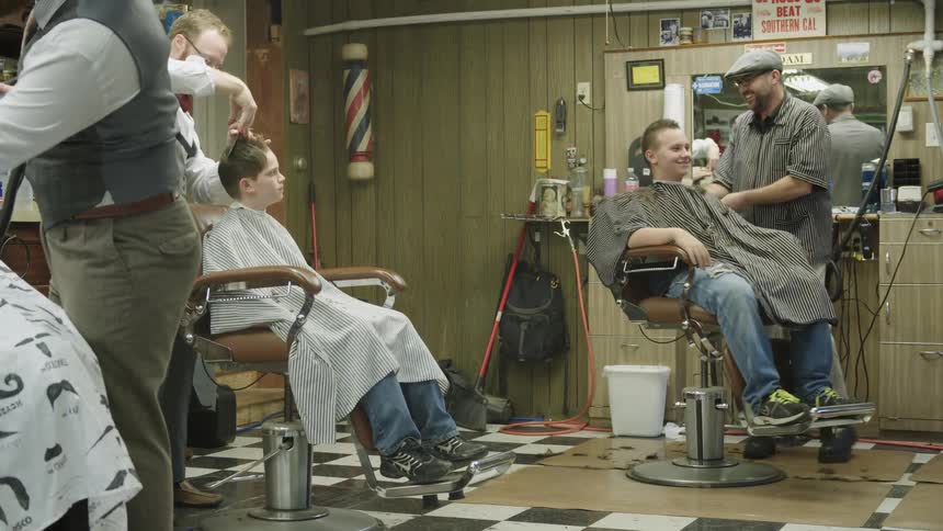 Barbers work in a barber shop