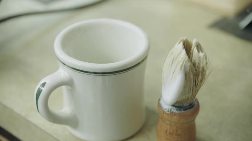 Coffee mug with a brush next to it