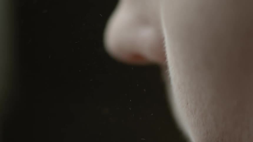 A person is applying makeup with a brush