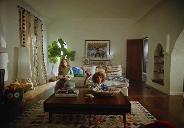 Two children sitting in a room watching