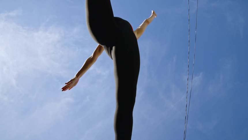 A woman in exercise clothing runs and jumps