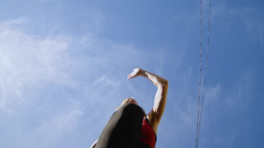 Upward view of a woman jumping while running