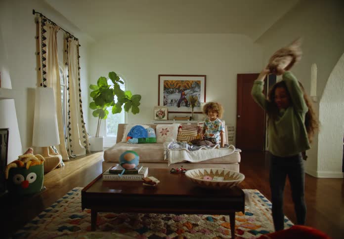 Two girls play in a living room