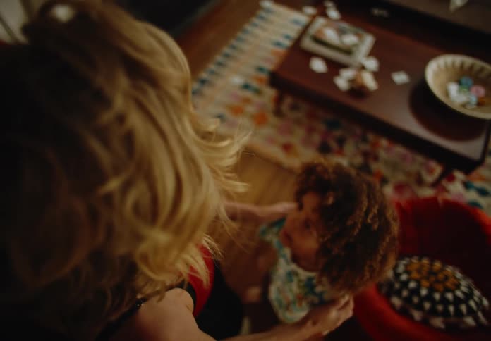 Top view of mother in room with two children who are playing