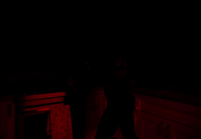 Blonde woman dancing in kitchen with red lights flashing