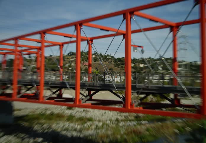 A woman jogs across a bridge