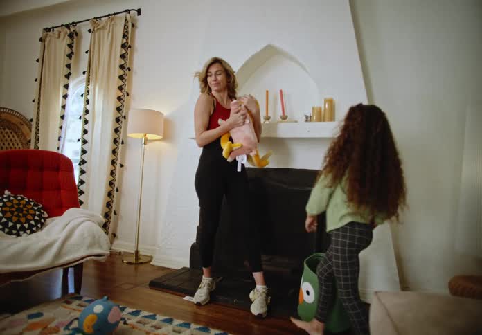 Child taking the stuffed animal and giving it to his mother and is very smiling