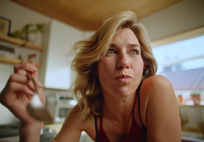 A woman is eating cereal