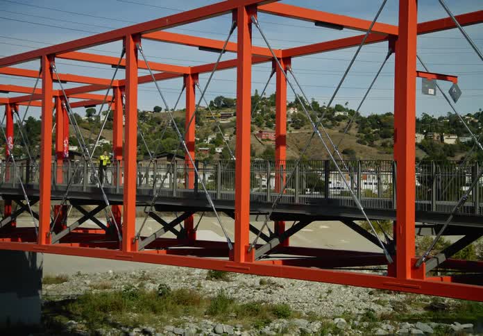 A woman jogs over the bridge