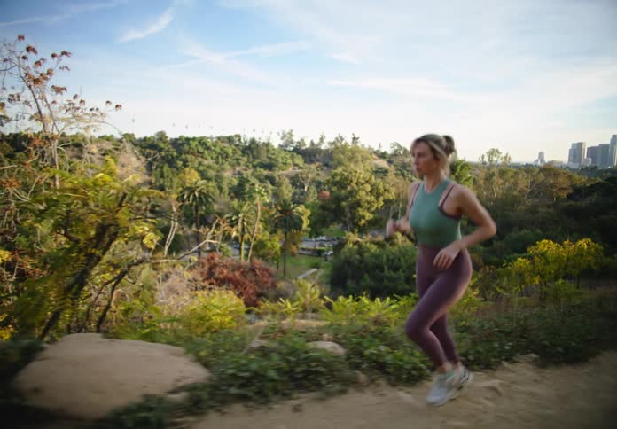 A woman exercising in a city park during the day