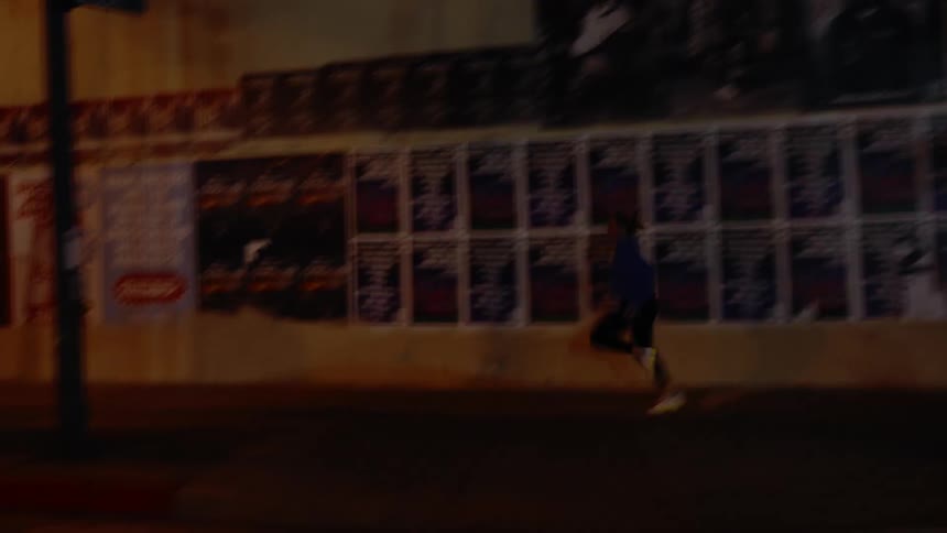 Woman jogging in the city streets at night