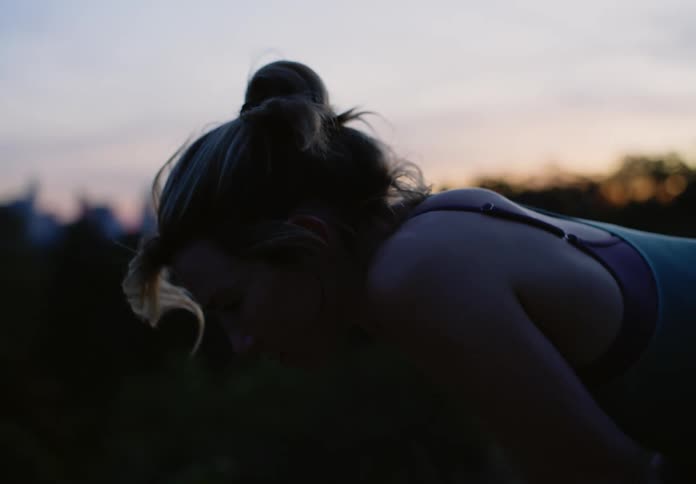 A woman resting after a run in nature