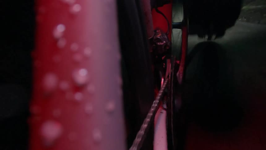 Camera attached to the rear wheel of a bicycle and a person cycling at night