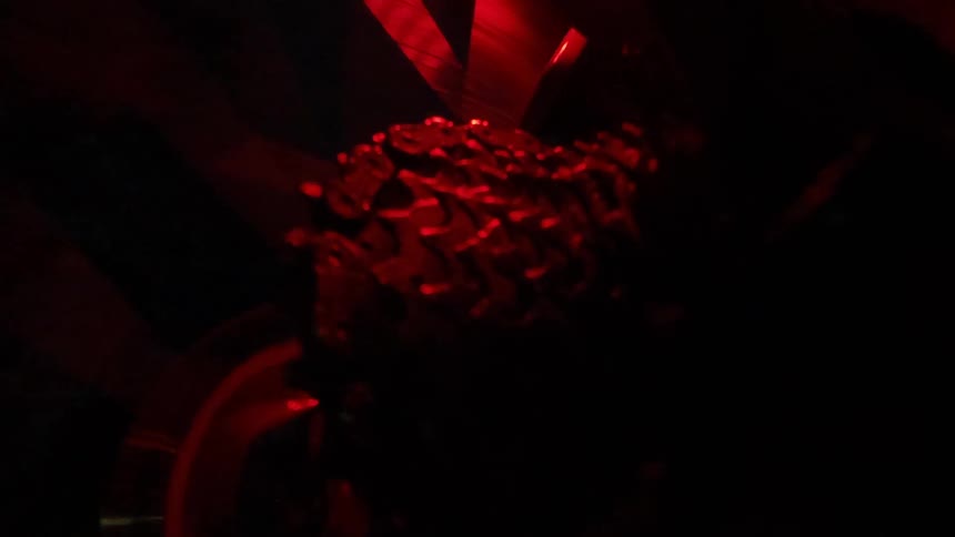A bicycle wheel spins and moves the chain