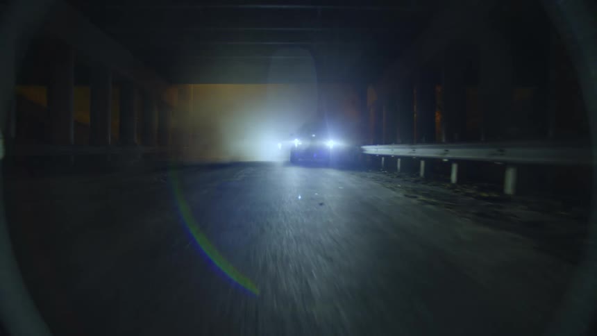 A police car begins following a racing bicycle through the tunnel