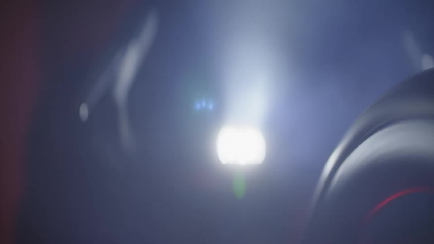 Closeup of the front of the bicycle with a flashlight illuminating the night