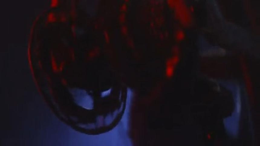 Close up of a bicycle bearing crank and a person pedaling at night