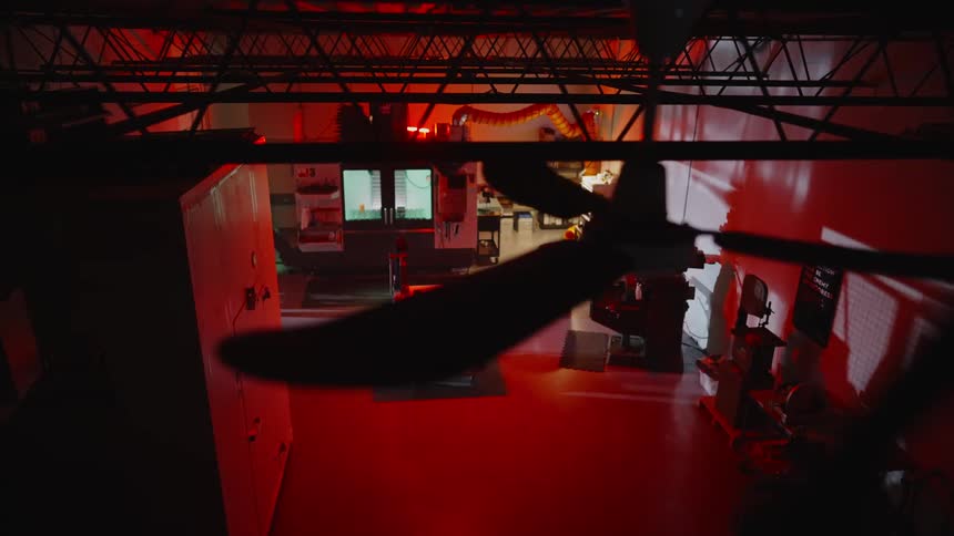 A man searches through the room with a flashlight