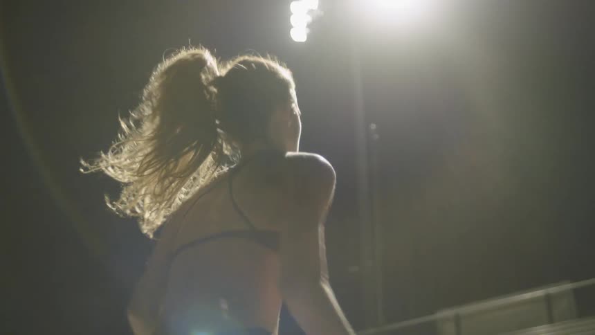A woman runs up bleachers