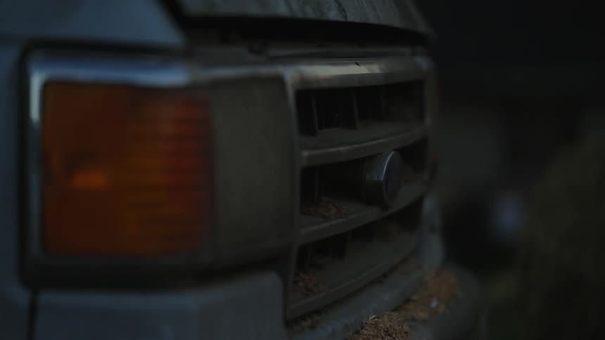 Closeup of the bumper of a dirty vehicle and its flashlight