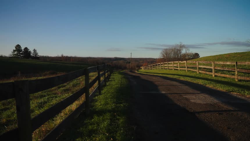 Green fields are behind the fence