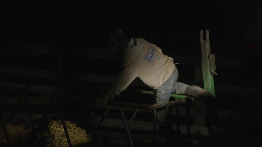 Man jumps over a wooden fence at night