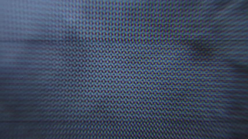 Closeup on a monitor playing a video of a person riding a bicycle down the street