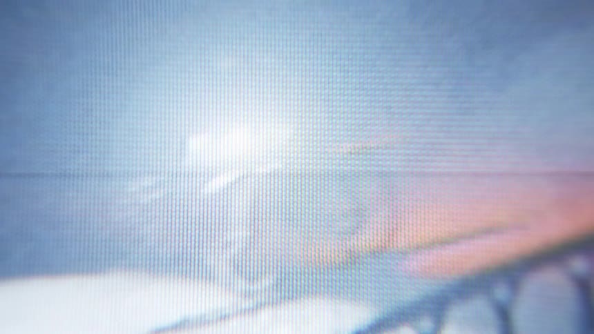 Video from a camera of a person passing by on a bicycle at night
