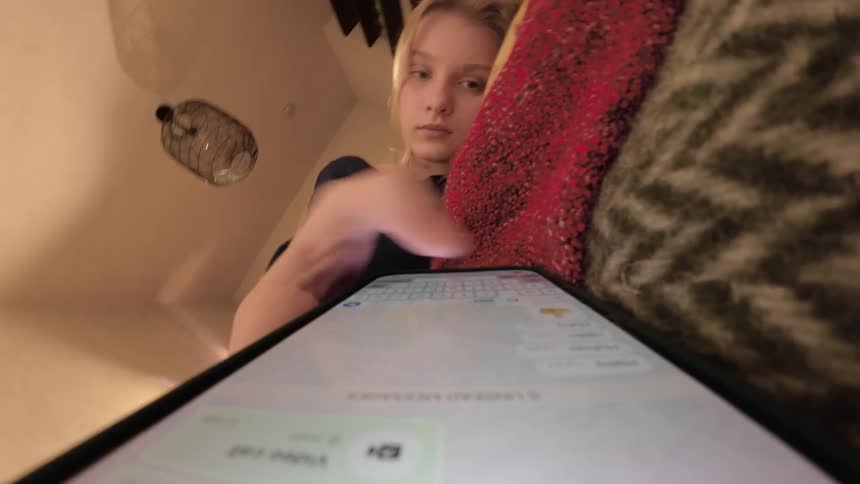A girl is sending messages on her cell phone