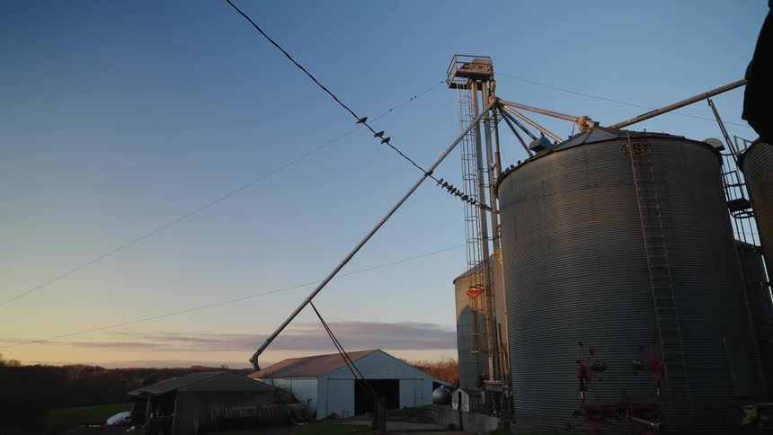 A farm with a large reservoir during sunset