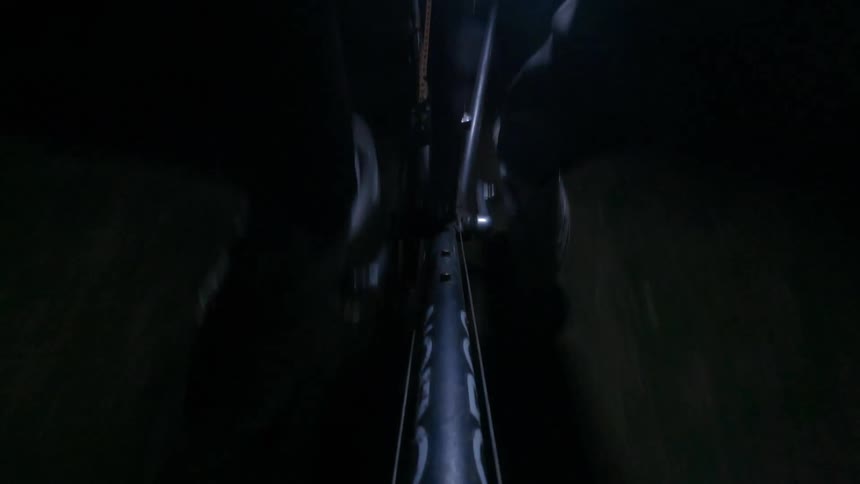 A person is riding his bike at night