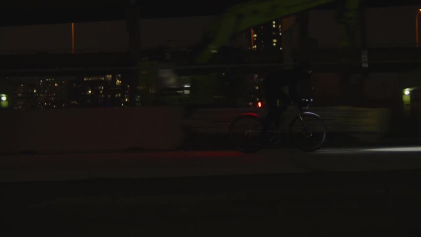 A man is racing his bicycle through the city