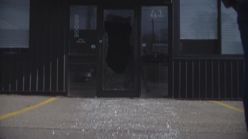 A store with a broken glass door