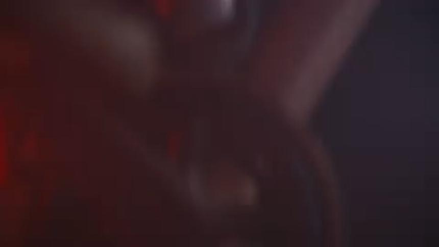 Closeup on the feet of a man pedaling a bicycle quickly at night