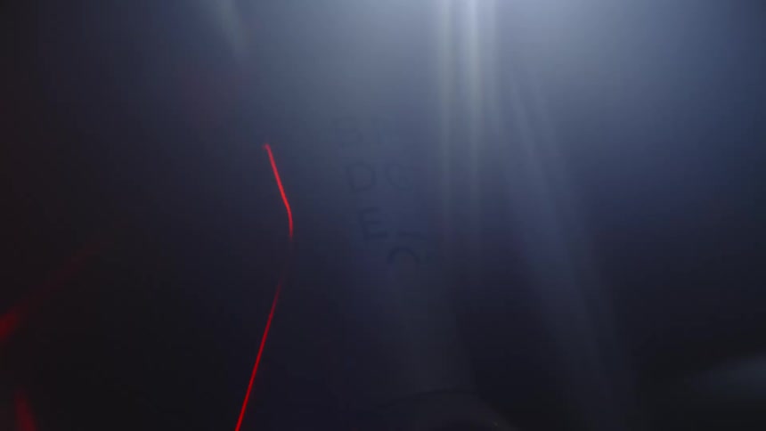 Close up of a person pedaling on a static bicycle in a dark room